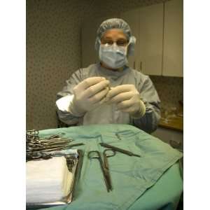  A Surgeon Readies a Scalpel in an Operating Room Prior to 