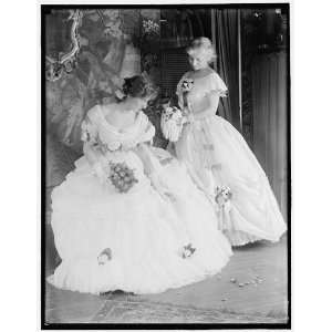   Virginia Gerson seated,as her sister admires her gown