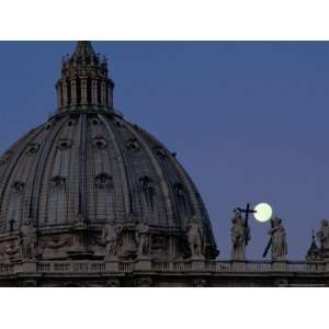  A Full Moon Rises over the Dome of St. Peters Basilica 
