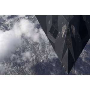  An F 117A Nighthawk Flies High Over the Mountains Above 