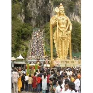 Statue of Hindu Deity with Pilgrims Walking 272 Steps up to Batu Caves 